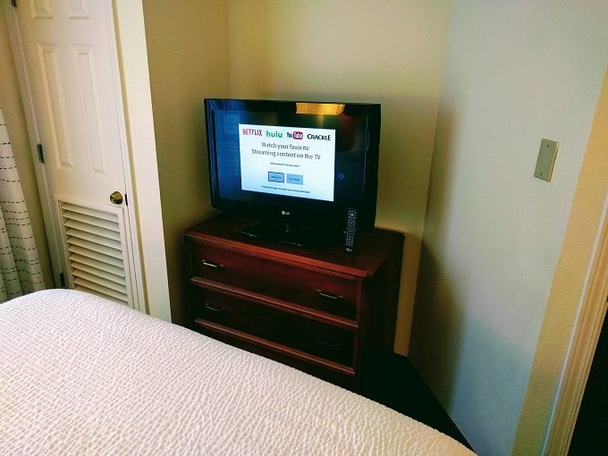 Residence Inn Atlanta Norcross Peachtree Corners TV and dresser in bedroom
