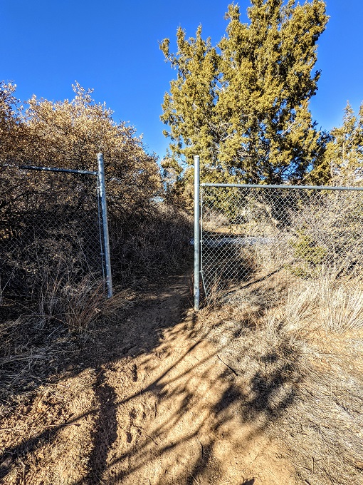 Continue through the gate in the fence