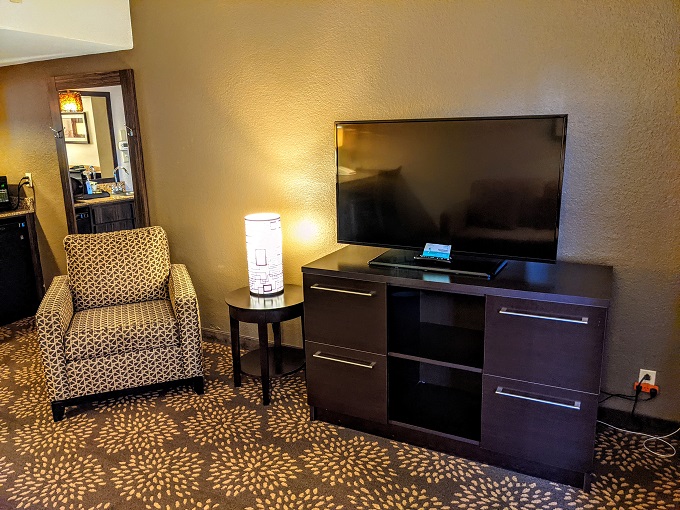Holiday Inn & Suites Phoenix Airport North, AZ - Armchair, TV & storage unit