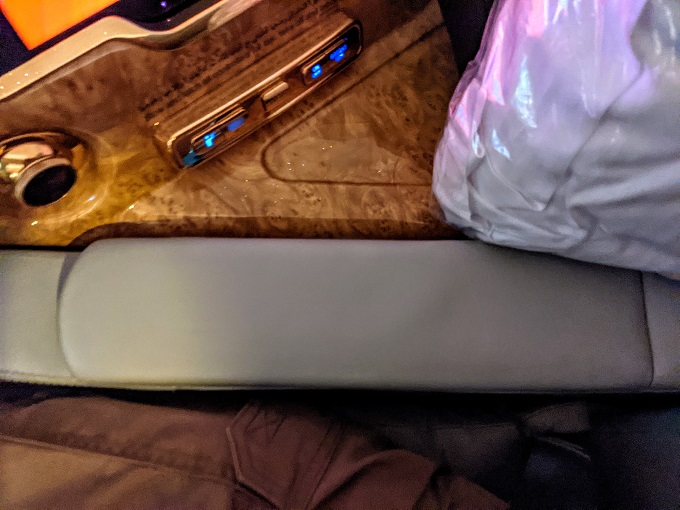 Emirates First Class - Seat arm rest containing TV controller
