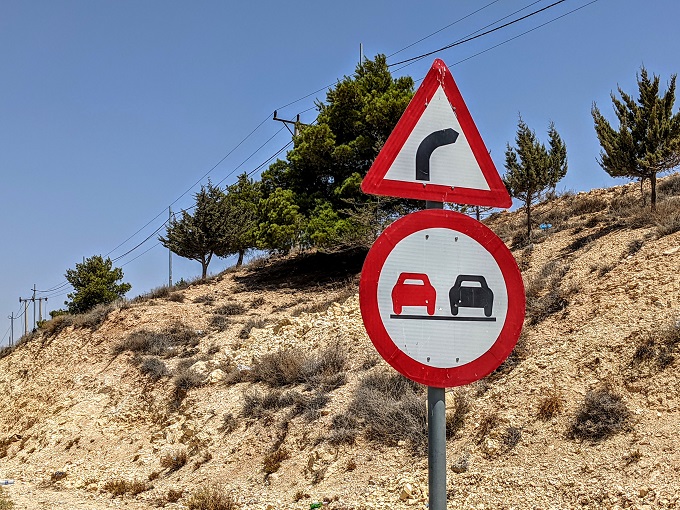 No Passing sign in Jordan (the one with the red car next to the black car)