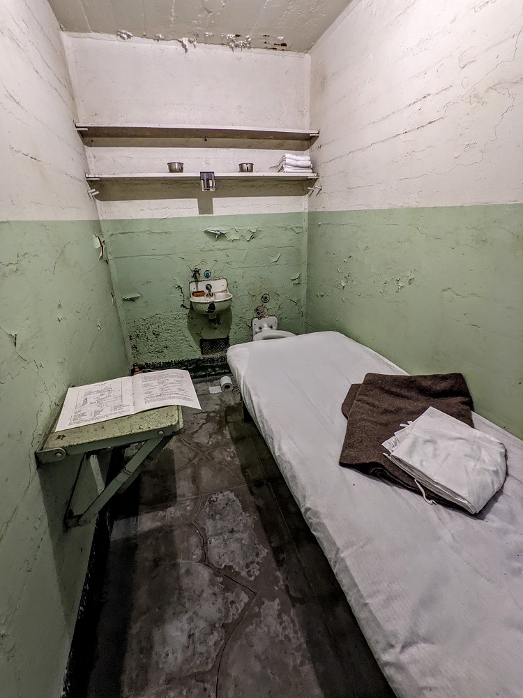 Alcatraz cell with copy of the rules & regulations on the table