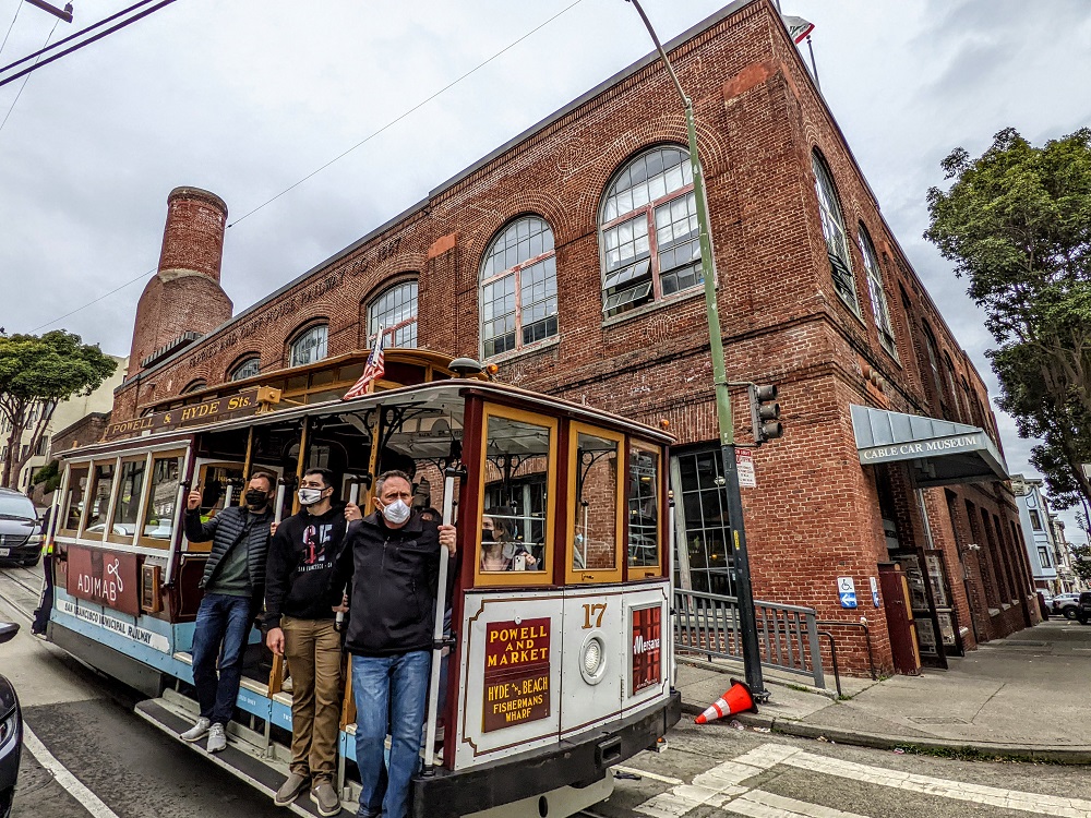 A cable car passing the Cable Car Museum in San Francisco