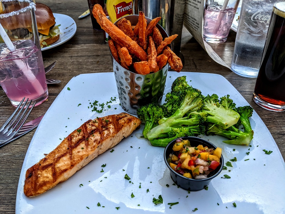 Salmon with sweet potato fries & broccoli at Open Range Grill & Tavern
