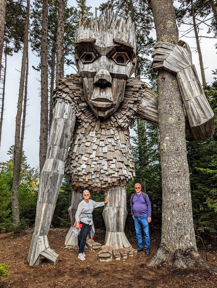 My parents with Roskva - Thomas Dambo troll at Coastal Maine Botanical Gardens Guardians of the Seeds