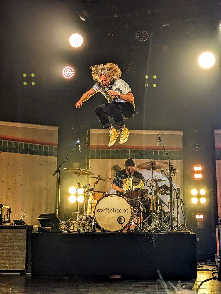 Jon Foreman jumping off the drumkit during a Switchfoot concert