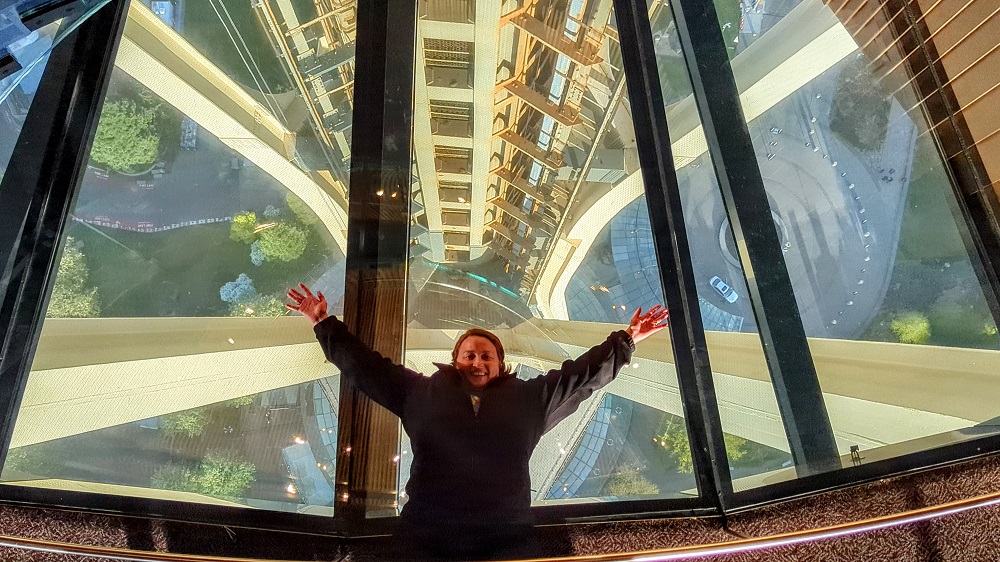 Shae laying on the glass floor of the Space Needle