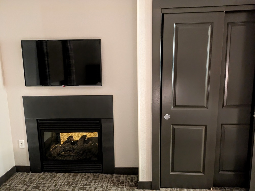 Homewood Suites Jackson, WY - Bedroom TV, closet & fireplace