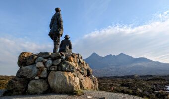 Collie & MacKenzie Statue looking out at the Cuillin on the Isle of Skye