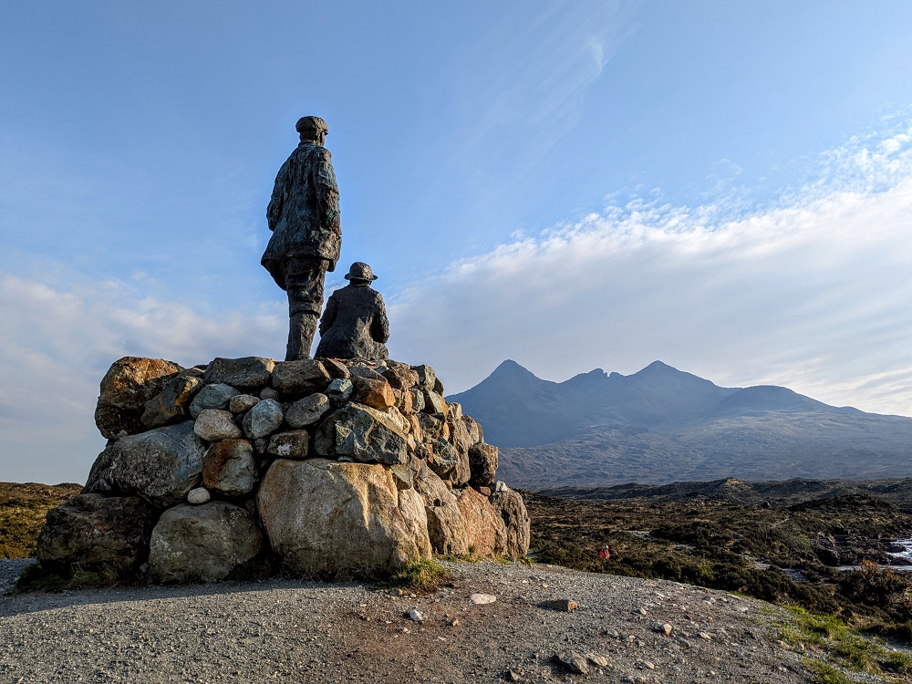 Collie & MacKenzie Statue looking out at the Cuillin on the Isle of Skye
