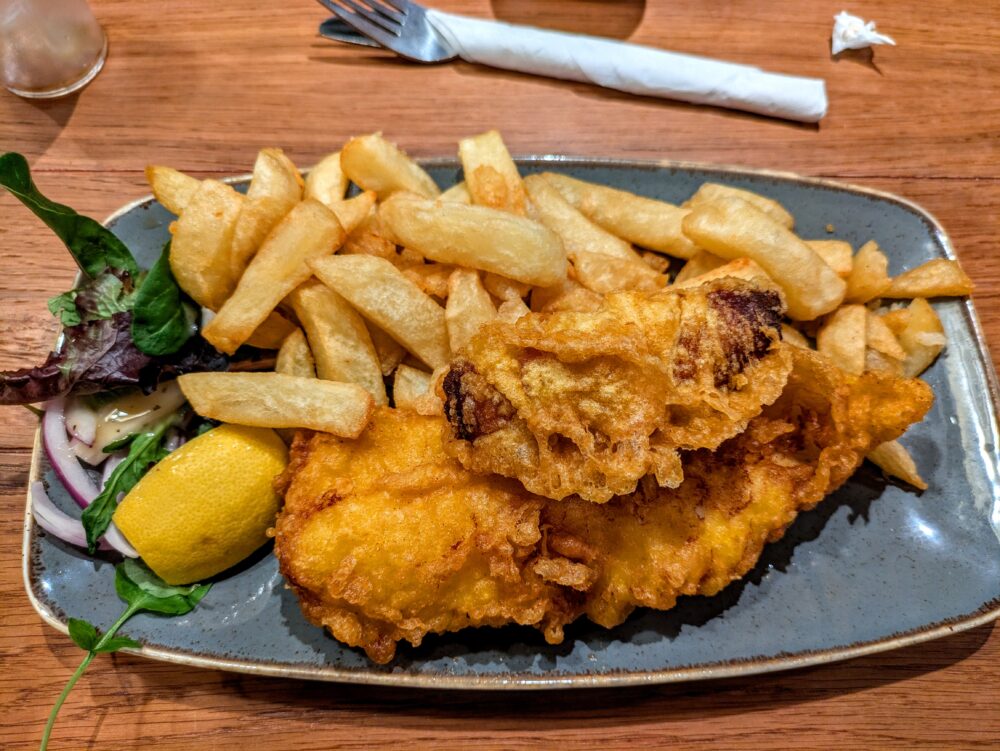 Fish & chips with a battered sausage at Rowlies Fish & Chips in Pembroke, Wales